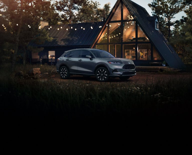 2027 Honda HR-V EX-L in Nordic Forest Pearl three quarter view parked in front of a cabin (Subcompact Crossover SUV). 2027 Honda HR-V EX-L in Nordic Forest Pearl three quarter view parked in front of a cabin (Subcompact Crossover SUV).