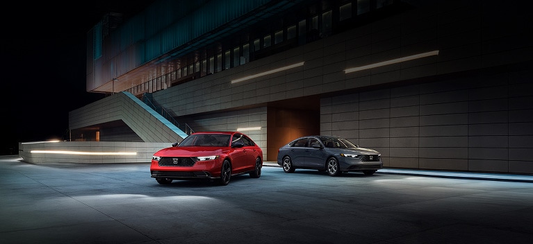 2026 Honda Accord Sport-L Hybrid shown in Radiant Red Metallic and Accord LX shown in Meteorite Gray Metallic (Mid-Size Sedan). 2026 Honda Accord Sport-L Hybrid shown in Radiant Red Metallic and Accord LX shown in Meteorite Gray Metallic (Mid-Size Sedan).