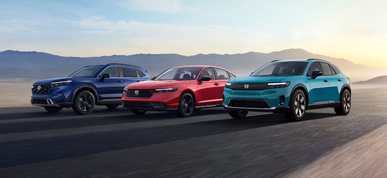 2025 Honda CR-V Hybrid, Honda Accord Hybrid and Honda Prologue in a street driving side by side 2025 Honda CR-V Hybrid, Honda Accord Hybrid and Honda Prologue in a street driving side by side